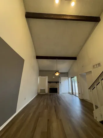 a view of a room with wooden floor