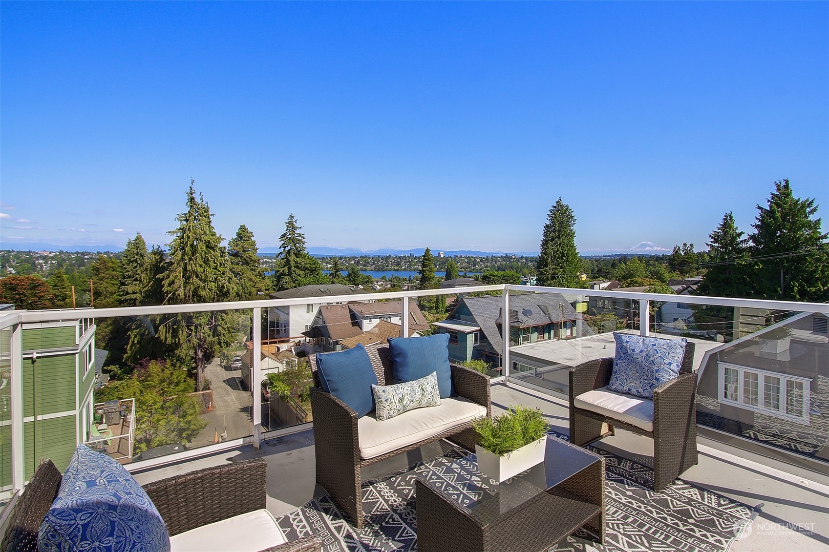 307 North 73rd Street, Unit 5 Seattle, WA 98103 - Photo 1 of 33 a roof deck with couches and wooden floor