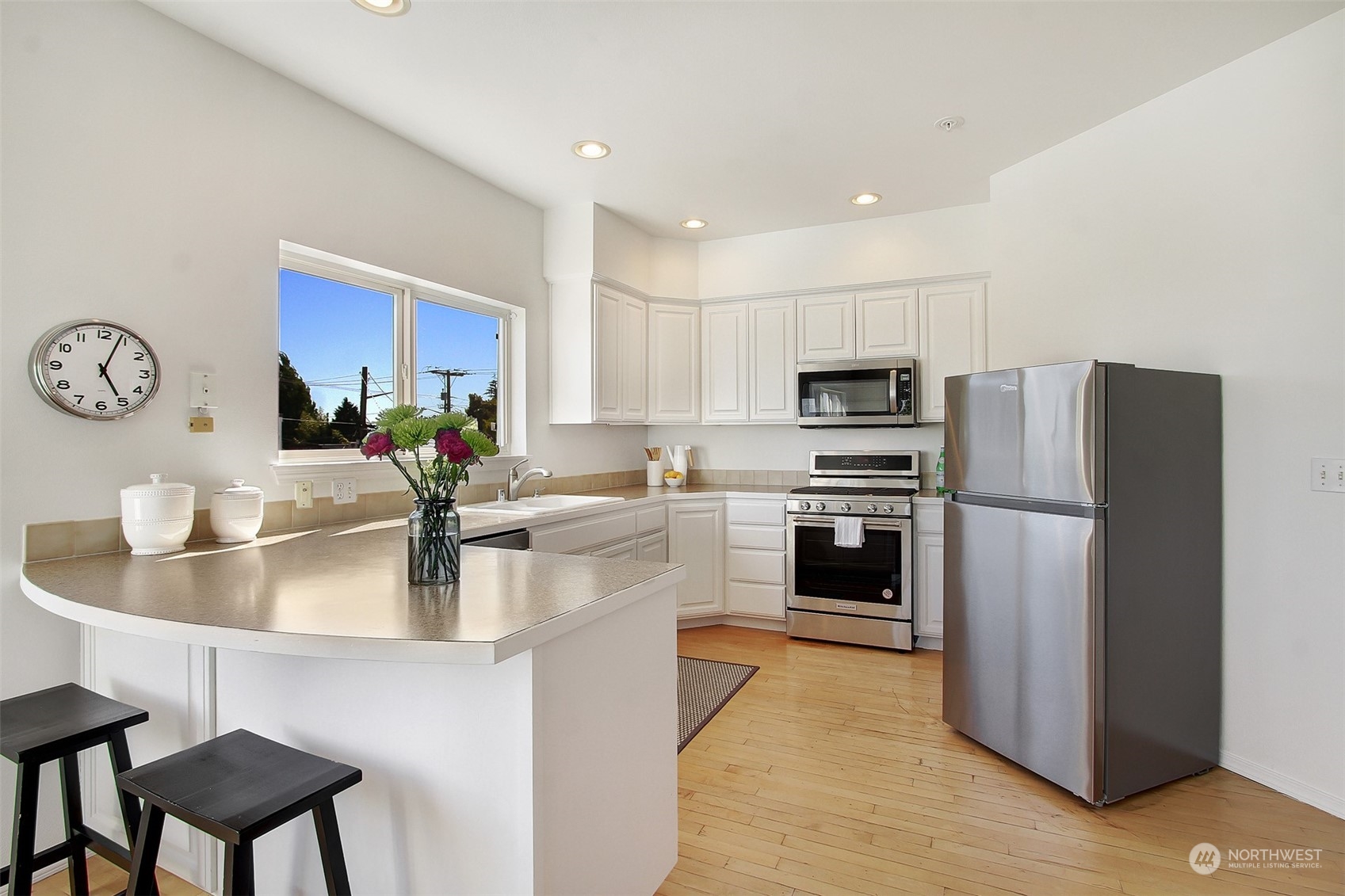 307 North 73rd Street, Unit 5 Seattle, WA 98103 - Photo 17 of 33 a kitchen with kitchen island a counter space a sink and appliances