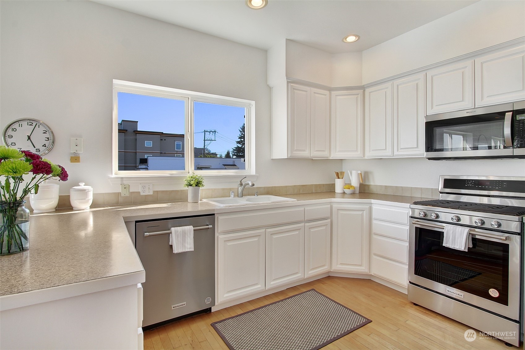 307 North 73rd Street, Unit 5 Seattle, WA 98103 - Photo 18 of 33 a kitchen with stainless steel appliances granite countertop a sink stove and cabinets
