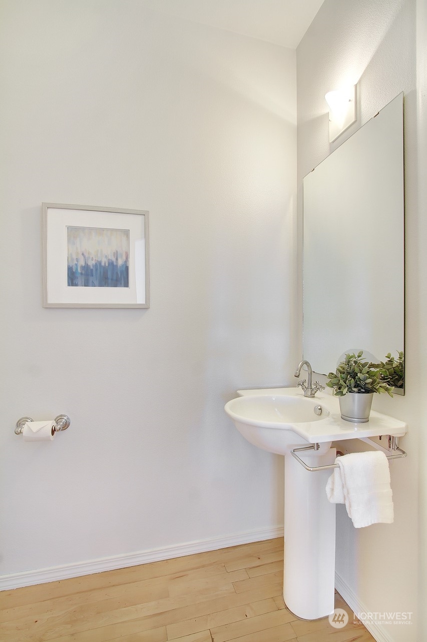 307 North 73rd Street, Unit 5 Seattle, WA 98103 - Photo 20 of 33 a bathroom with a sink and a mirror