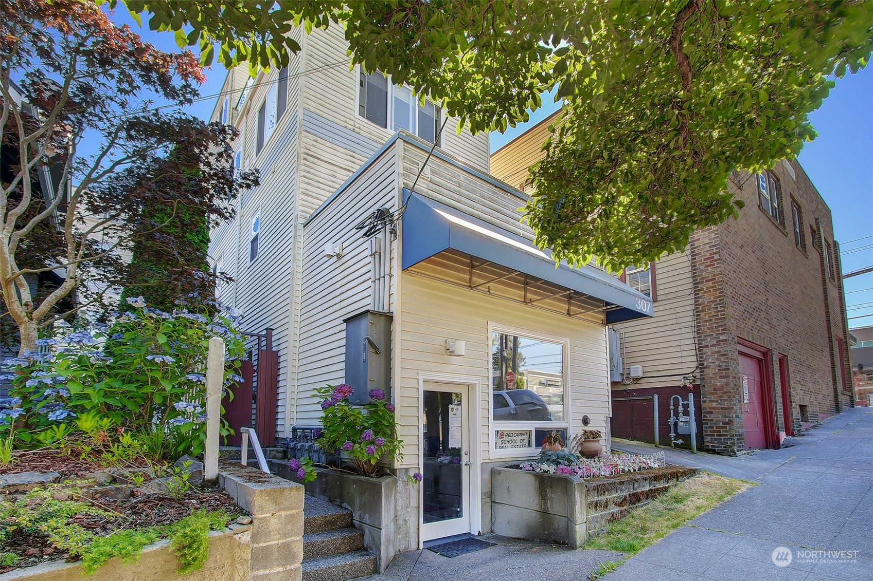 307 North 73rd Street, Unit 5 Seattle, WA 98103 - Photo 2 of 33 a view of a house with a chairs in patio