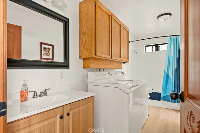 a utility room with a sink washer and dryer