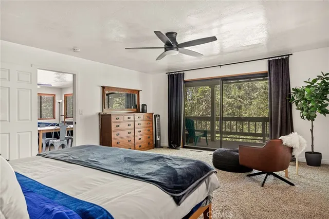 a spacious bedroom with a bed and wooden floor