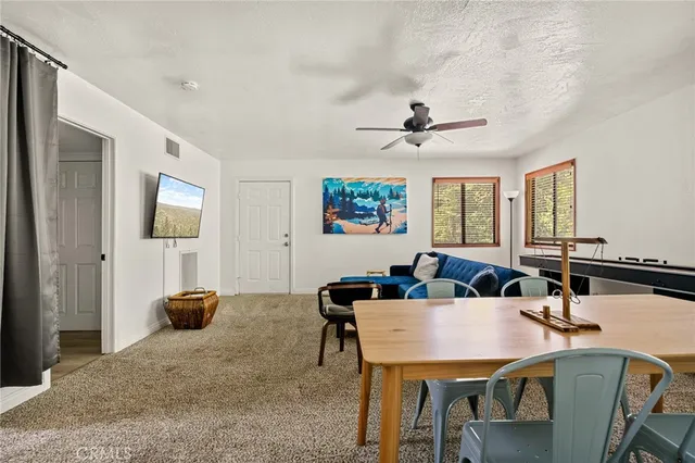a view of a livingroom with furniture and a window