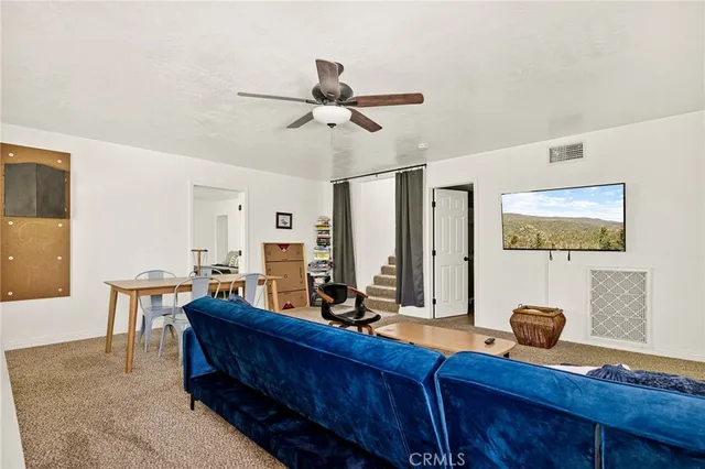 a view of a workspace with furniture and a mirror