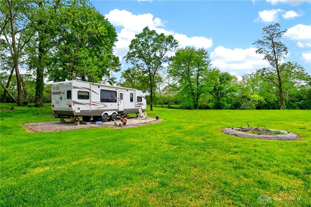 3889 Powell Road Huber Heights, OH 45424 - Photo 17 of 18 Expansive green space with room for recreation and a ready-to-use fire pit.