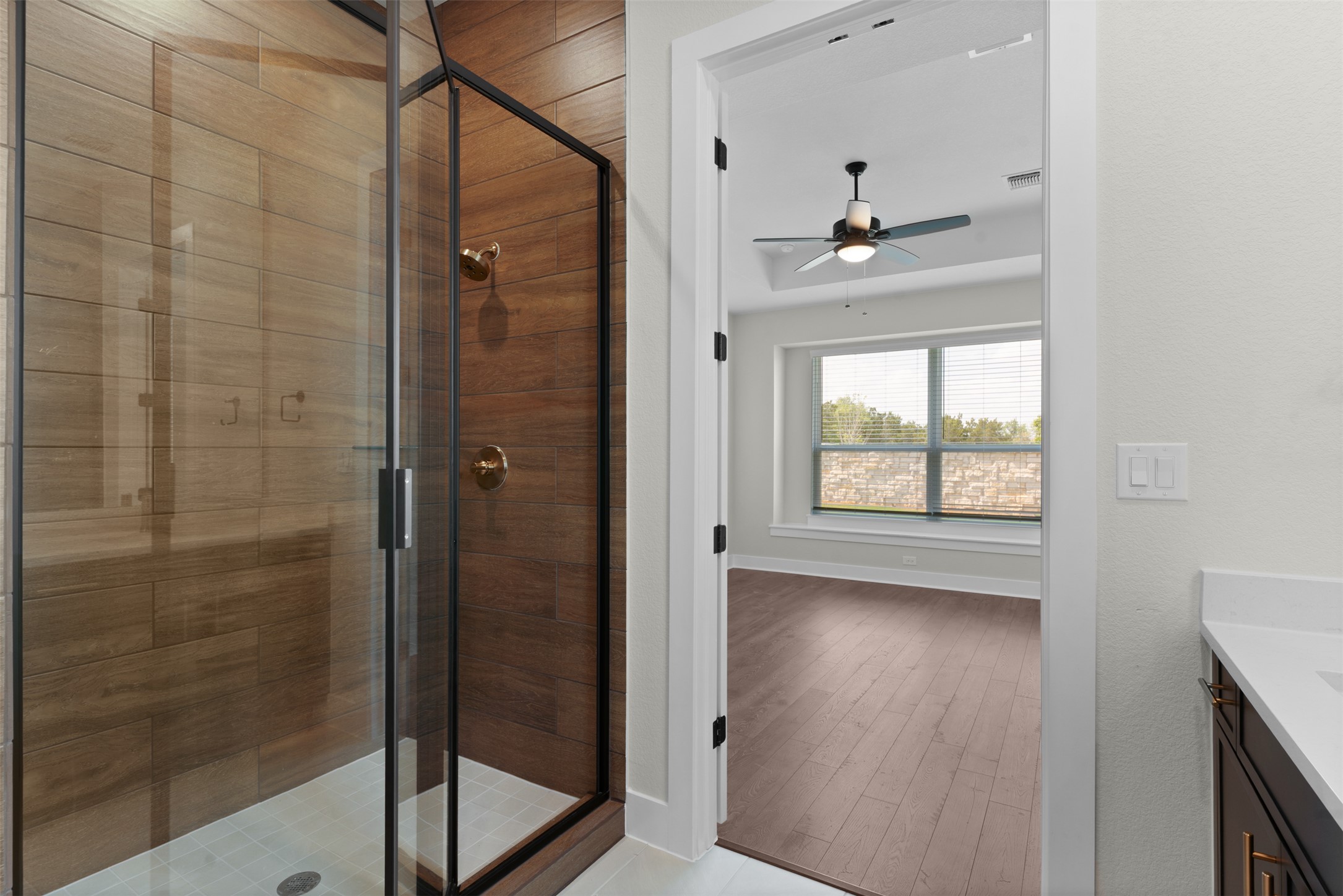 1121 Pansy Trail Georgetown, TX 78628 - Photo 14 of 25 Full bathroom with vanity, a shower stall, a ceiling fan, and light wood-style floors