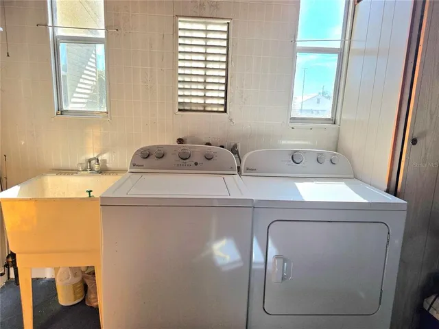a living room with furniture a fireplace and a large window