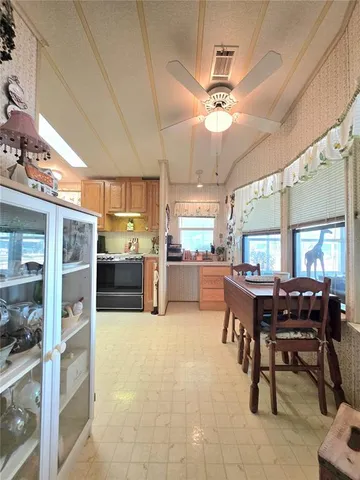 a spacious bedroom with a bed a dresser with wooden floor