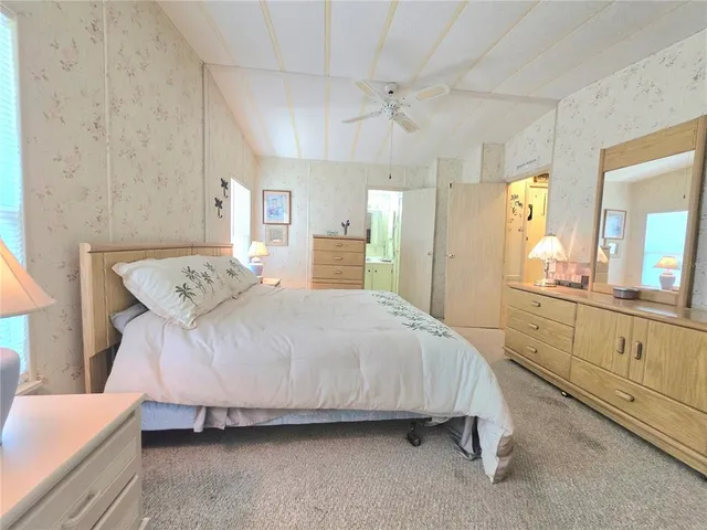 a view of a park with large trees and a barn in it