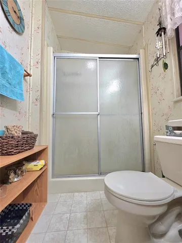 a view of a swimming pool with lawn chairs and a big yard