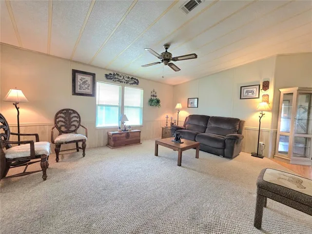 a view of a swimming pool with a yard in the background