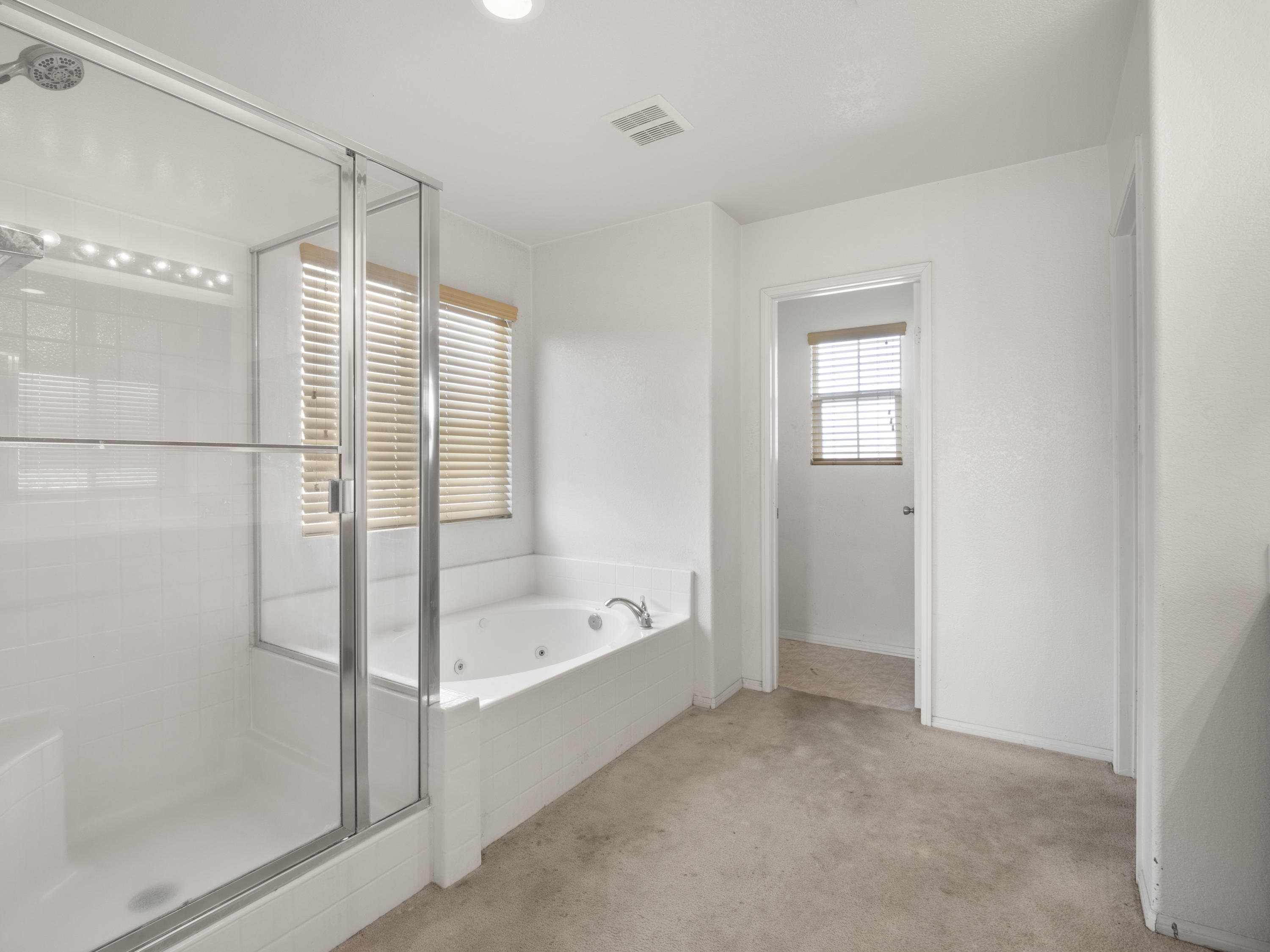 43635 Dana Drive Lancaster, CA 93535 - Photo 12 of 20 a bathroom with a bathtub and a shower