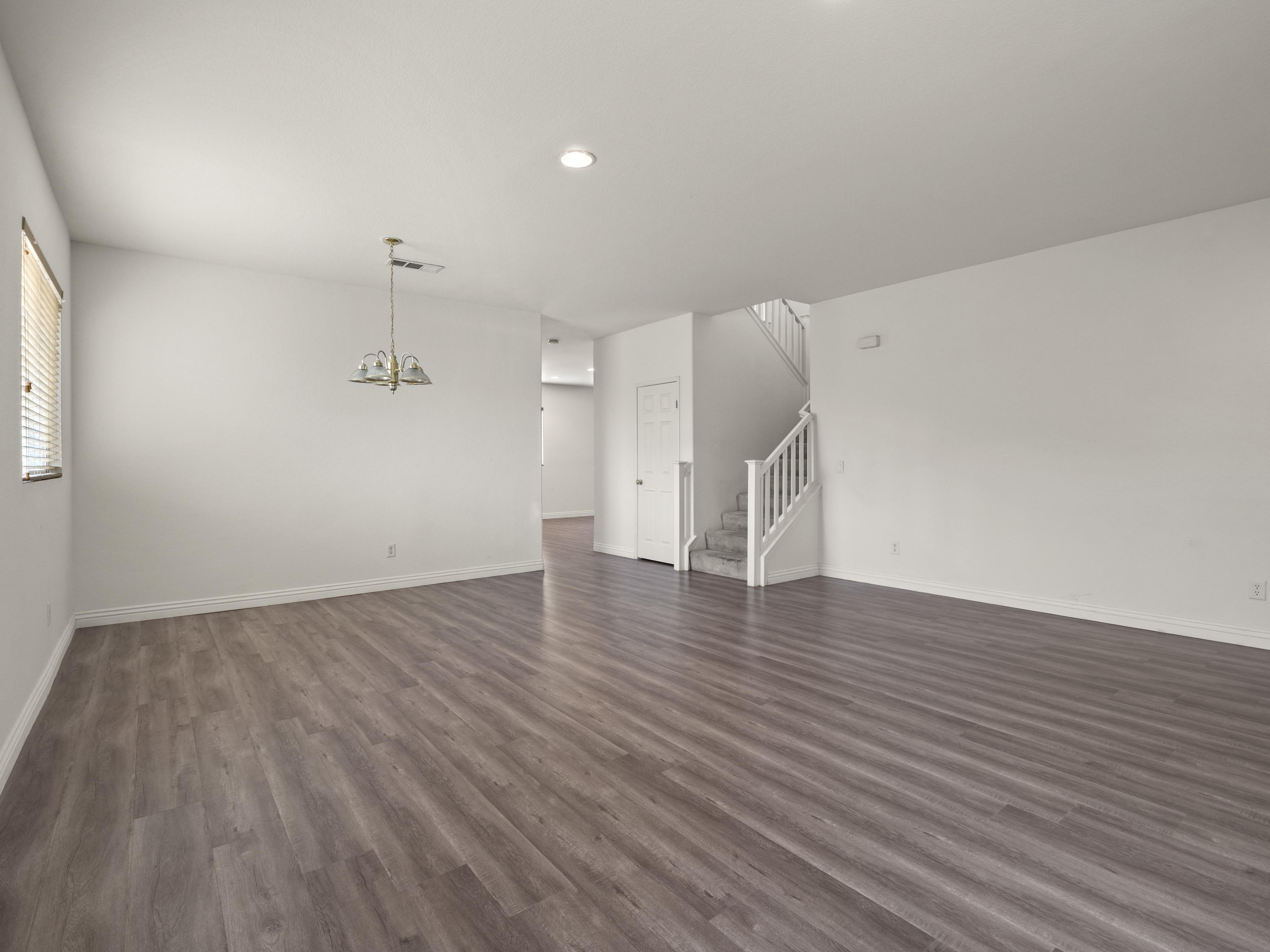 43635 Dana Drive Lancaster, CA 93535 - Photo 5 of 20 an empty room with wooden floor and windows