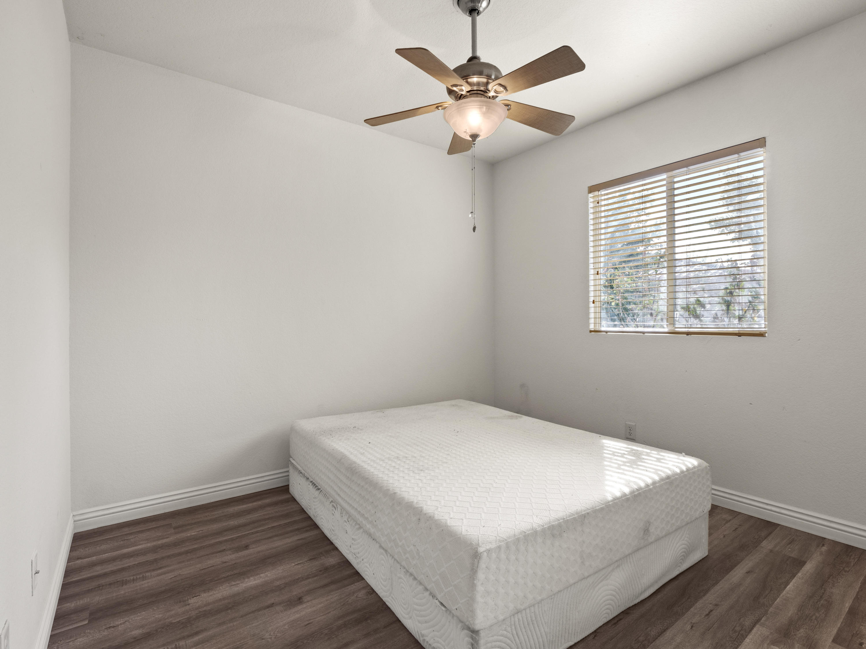 43635 Dana Drive Lancaster, CA 93535 - Photo 7 of 20 a view of a bedroom with wooden floor and fan