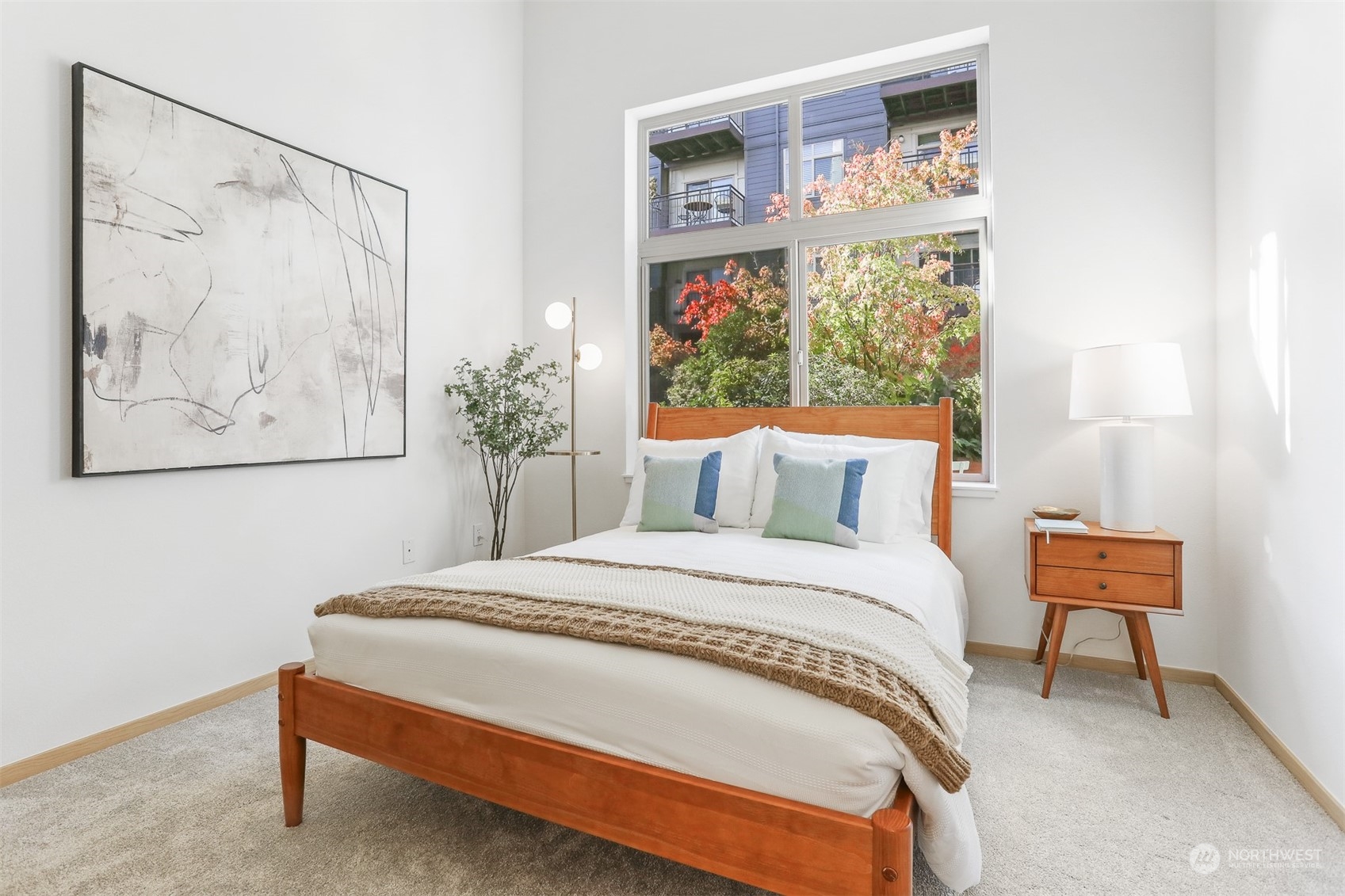3333 Wallingford Avenue North, Unit 101 Seattle, WA 98103 - Photo 12 of 26 a bedroom with a bed and a painting on the wall