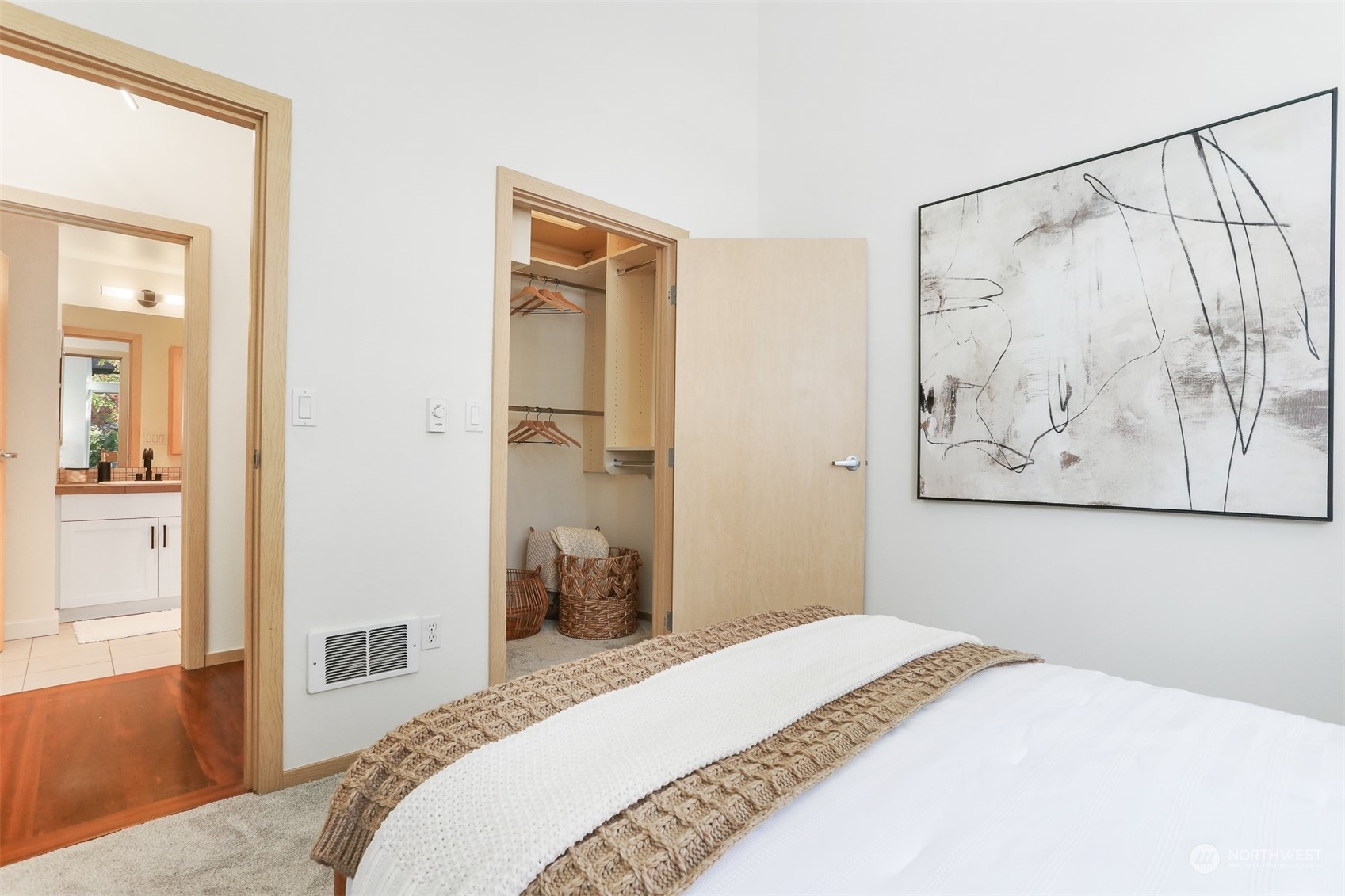 3333 Wallingford Avenue North, Unit 101 Seattle, WA 98103 - Photo 13 of 26 a bedroom with a bed and a painting on the wall