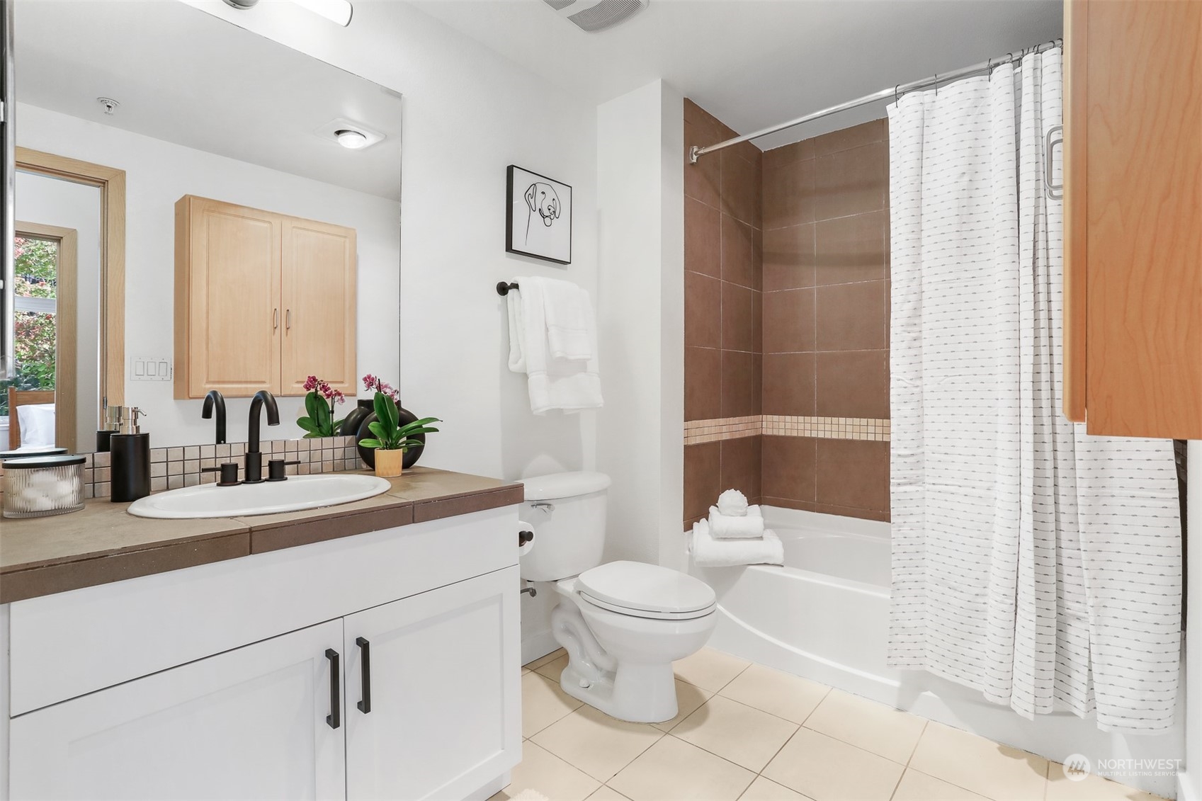 3333 Wallingford Avenue North, Unit 101 Seattle, WA 98103 - Photo 14 of 26 a bathroom with a sink a toilet and shower