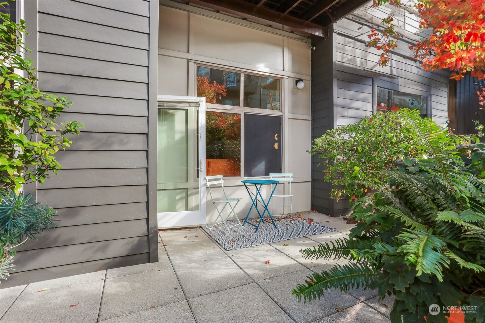 3333 Wallingford Avenue North, Unit 101 Seattle, WA 98103 - Photo 20 of 26 a view of a door and chair and potted plants in the patio