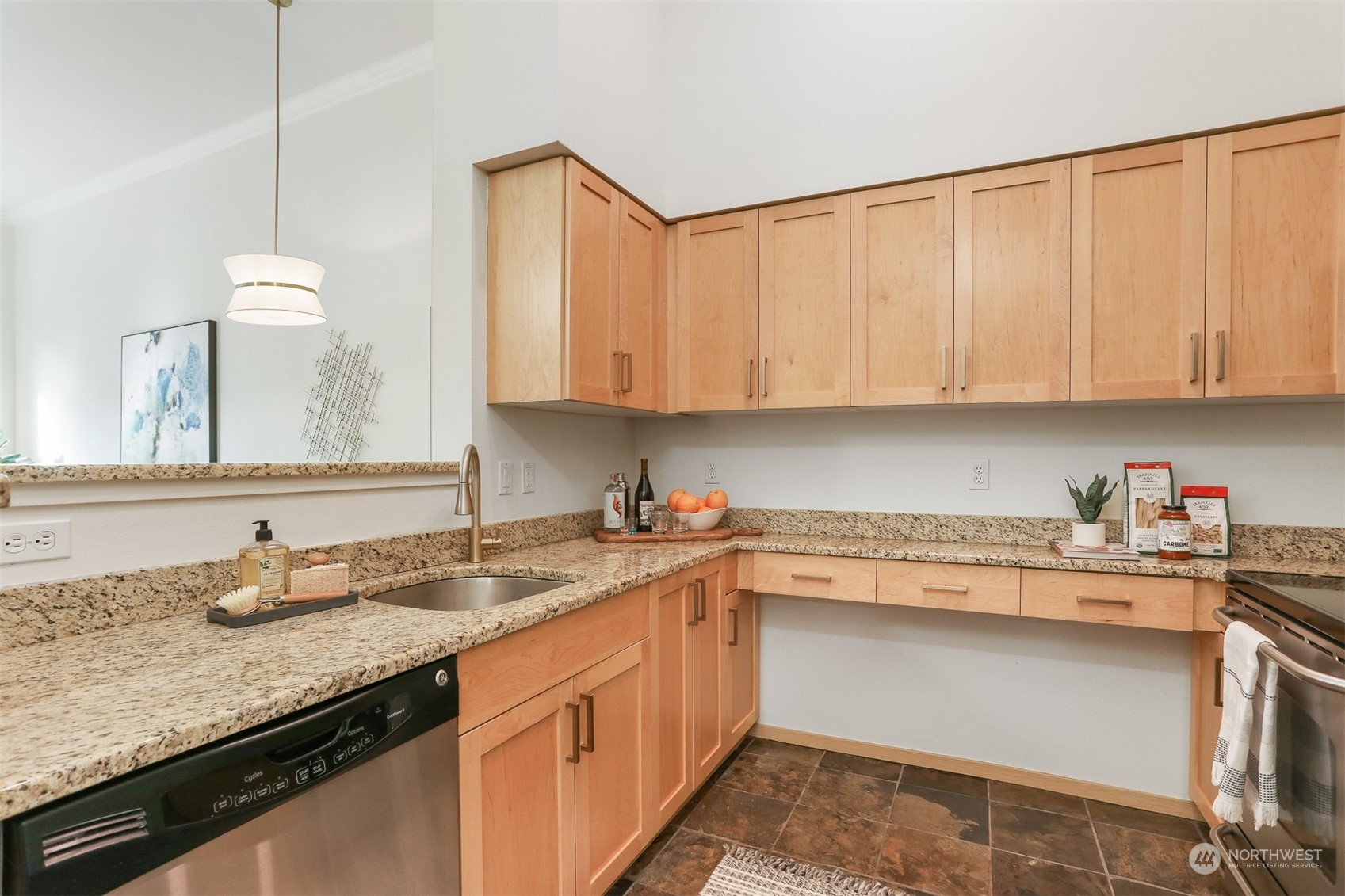 3333 Wallingford Avenue North, Unit 101 Seattle, WA 98103 - Photo 9 of 26 a kitchen with granite countertop a sink a stove and cabinets