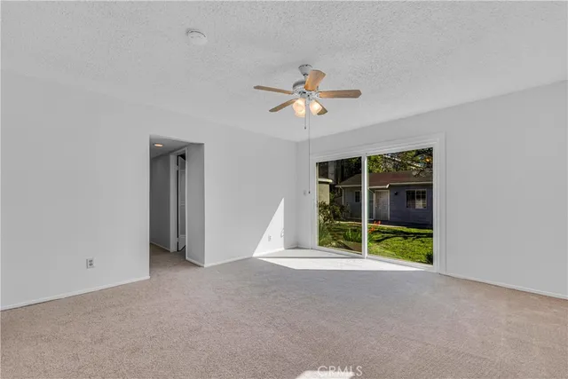 a bedroom with a bed and a large window with outer view
