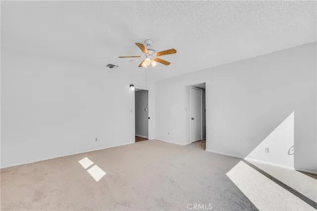 a very nice looking room with a ceiling fan