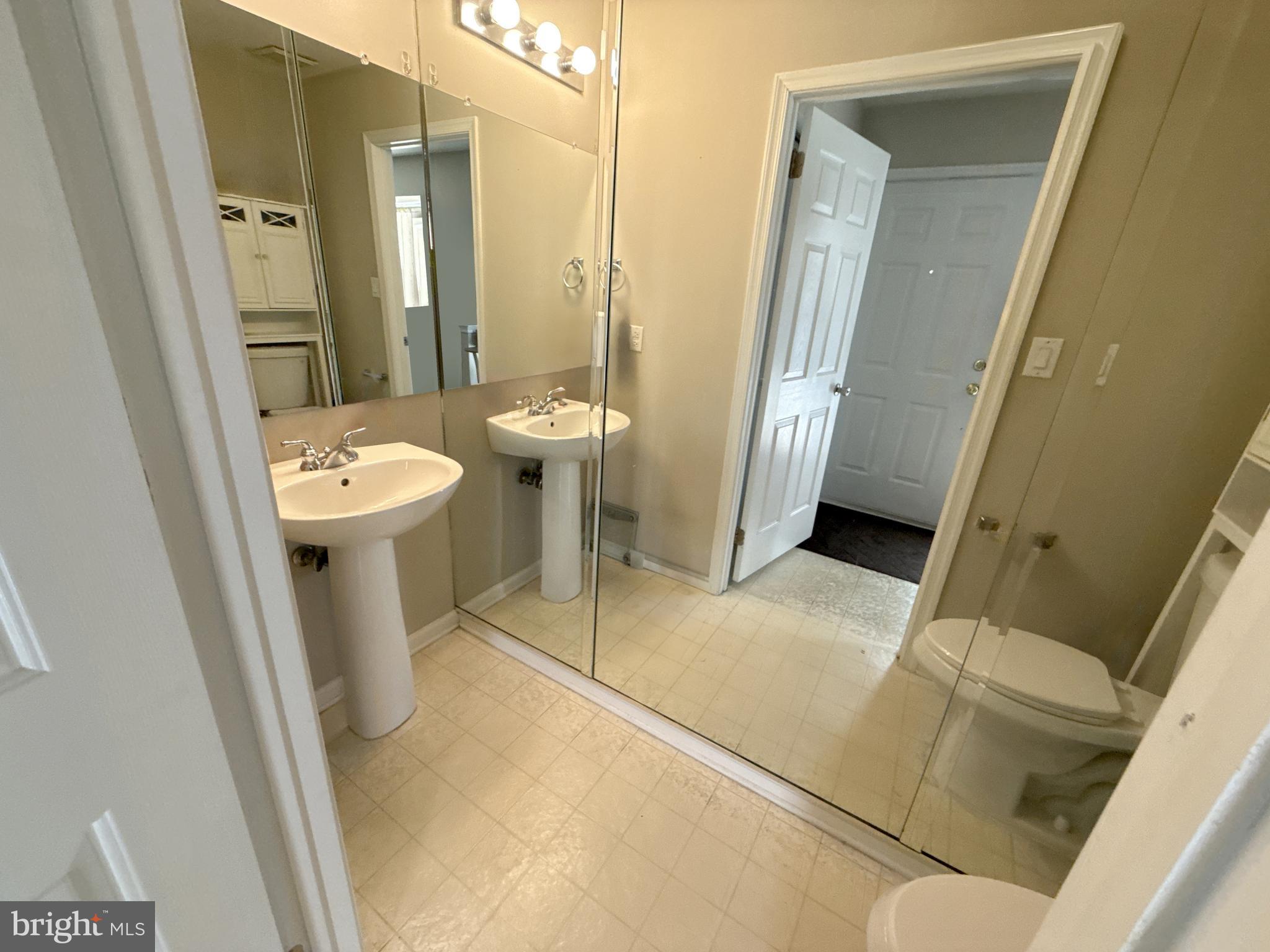 1203 Stokes Road Mount Laurel, NJ 08054 - Photo 4 of 7 a bathroom with a sink a toilet a mirror and tub