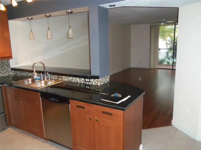 a kitchen with a sink and a refrigerator