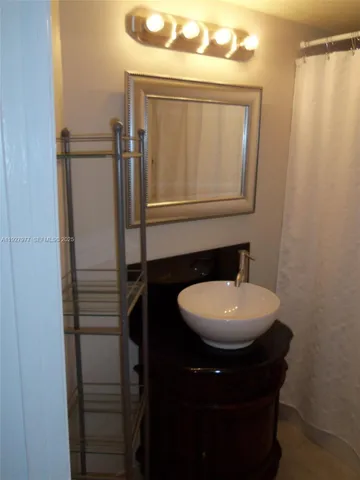 a bathroom with a sink a toilet and mirror