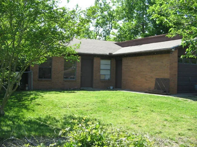 a backyard of a house with large trees
