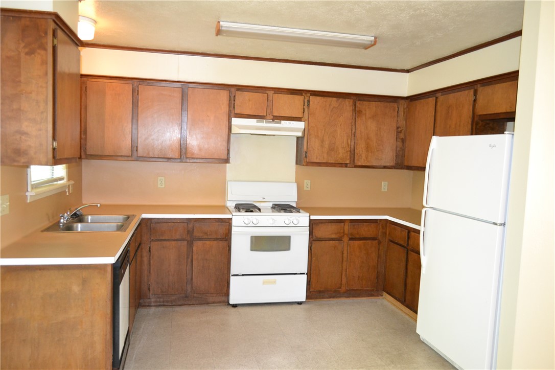 1116 Dexter Drive South College Station, TX 77840 - Photo 2 of 11 a kitchen with a stove a sink and a refrigerator
