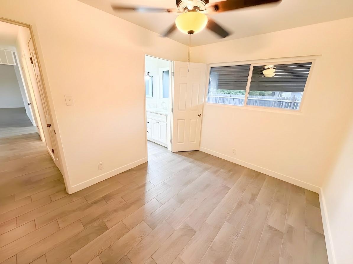 302 Sequoia Drive Exeter, CA 93221 - Photo 16 of 20 a view of a hallway with wooden floor and chandelier