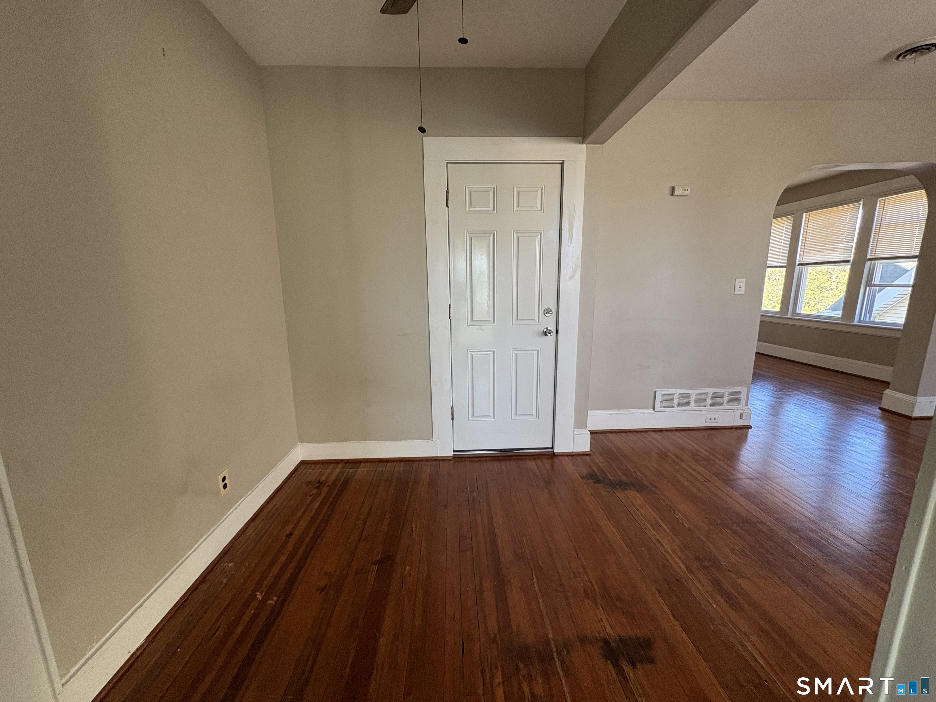 164 French Street, Unit 3 Bridgeport, CT 06606 - Photo 4 of 13 a view of an empty room with wooden floor and a window