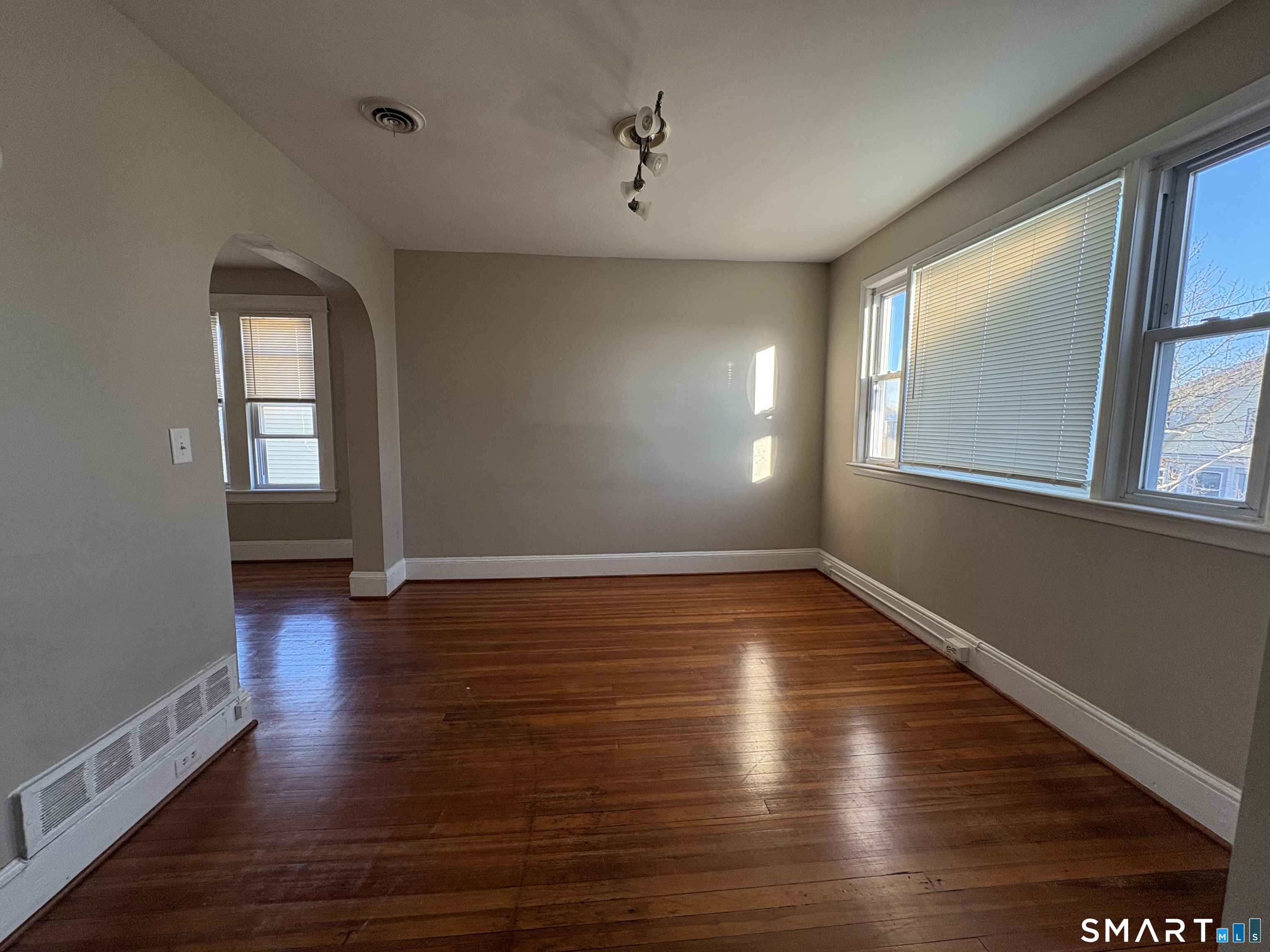 164 French Street, Unit 3 Bridgeport, CT 06606 - Photo 5 of 13 a view of an empty room with wooden floor and a window