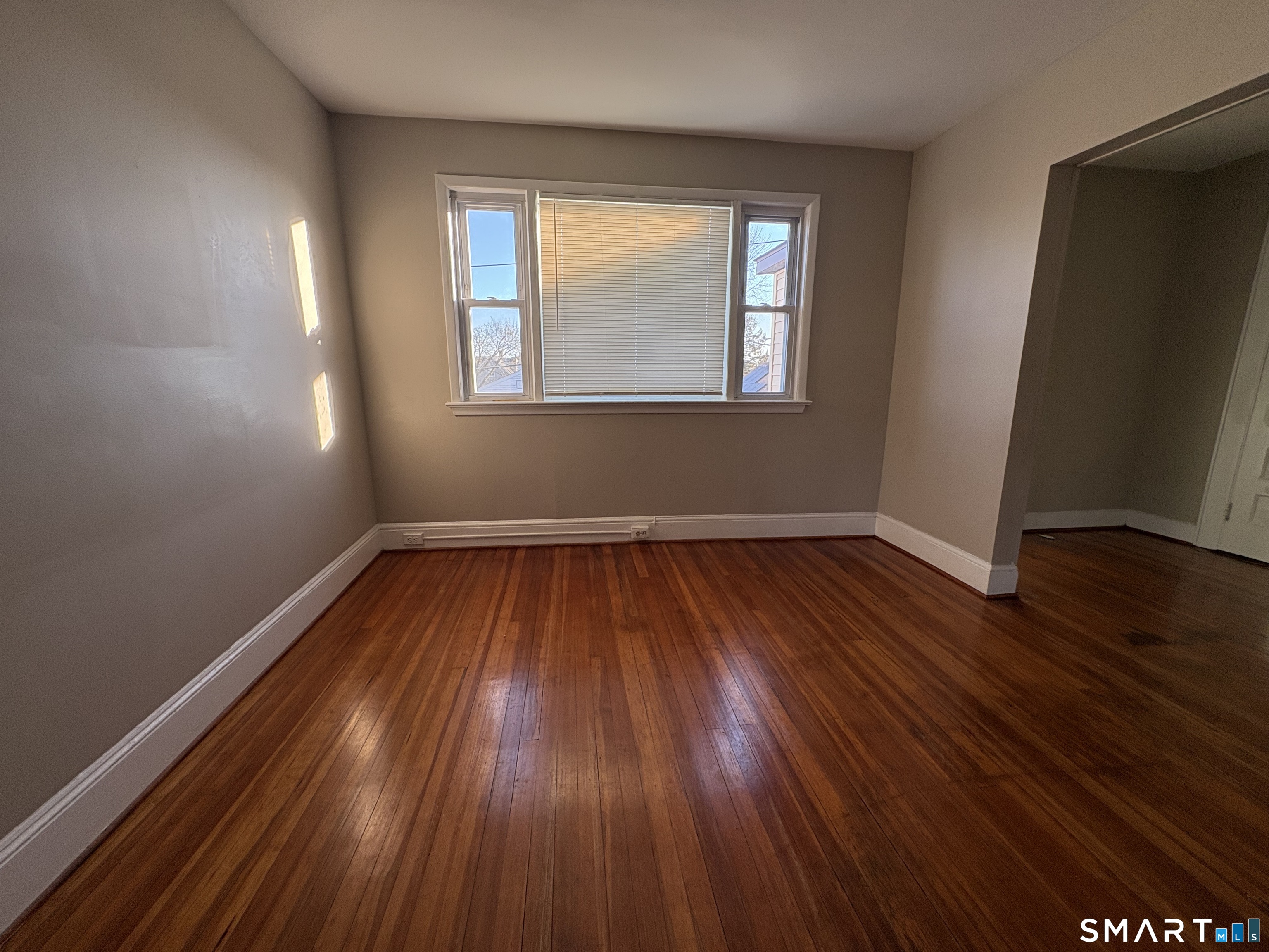 164 French Street, Unit 3 Bridgeport, CT 06606 - Photo 6 of 13 an empty room with wooden floor and windows