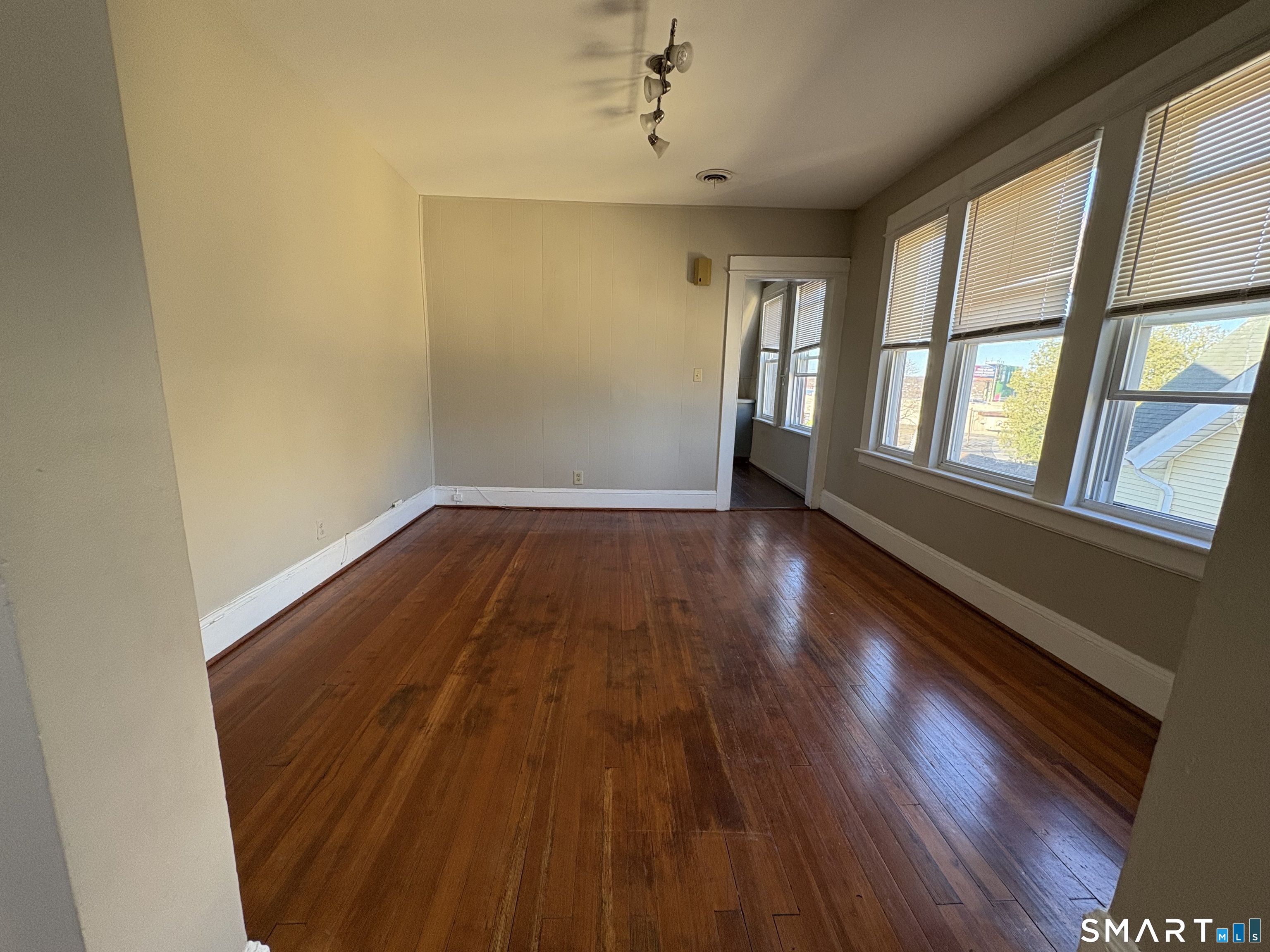164 French Street, Unit 3 Bridgeport, CT 06606 - Photo 7 of 13 wooden floor in an empty room with a window