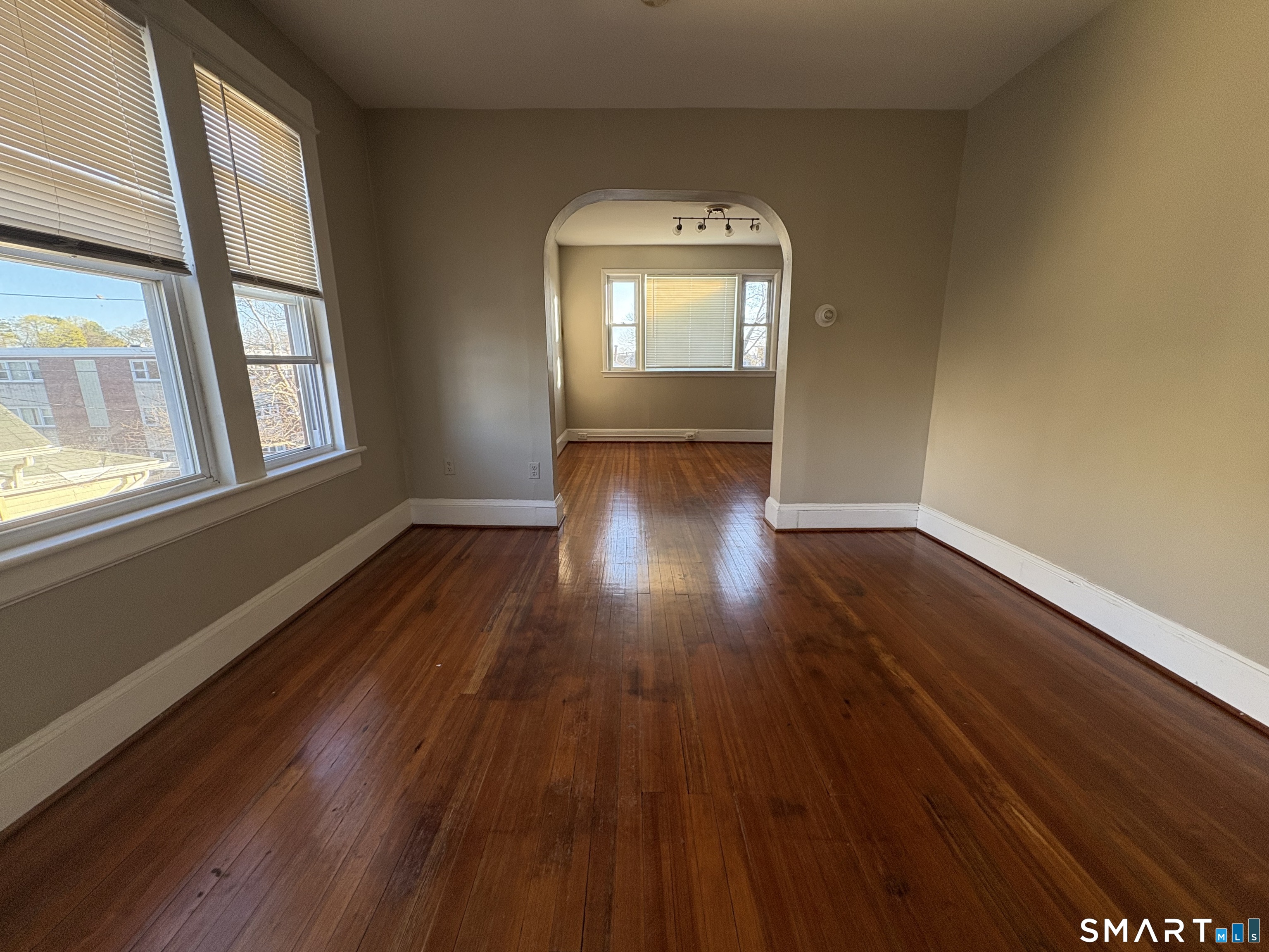 164 French Street, Unit 3 Bridgeport, CT 06606 - Photo 8 of 13 an empty room with wooden floor and windows