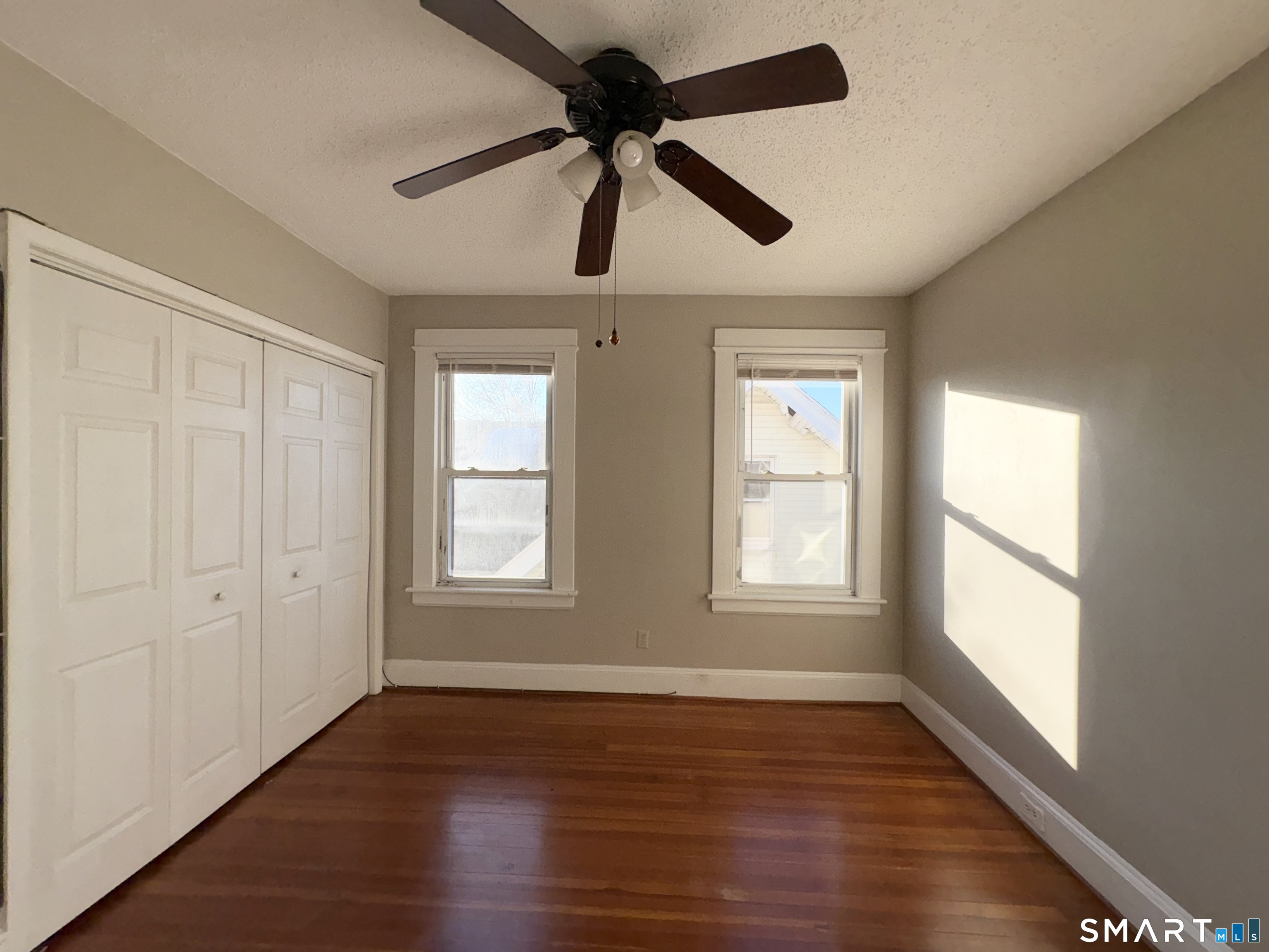 164 French Street, Unit 3 Bridgeport, CT 06606 - Photo 10 of 13 a view of an empty room with wooden floor and a window