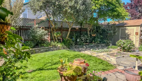 a view of a house with a yard and sitting area