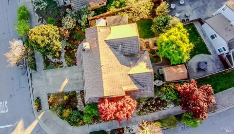 an aerial view of a house with a yard and garden