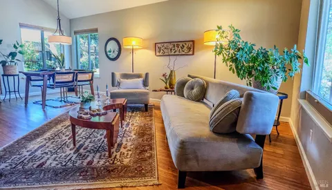 a living room with furniture and a clock