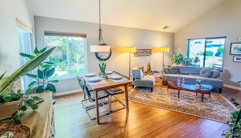 a living room with furniture a table and a large window