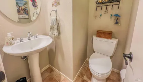 a white toilet sitting next to a bathroom sink