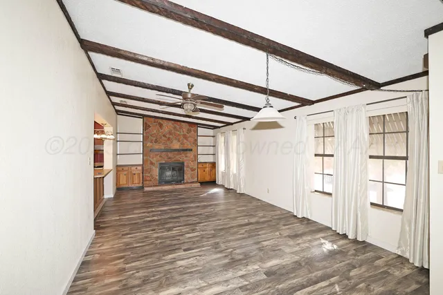 a view of a hallway with wooden floor and entryway