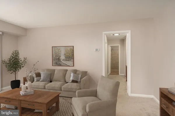 a living room with furniture and a potted plant