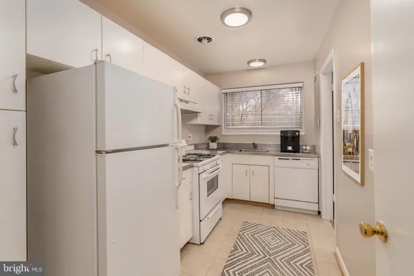 a kitchen with a refrigerator sink and cabinets