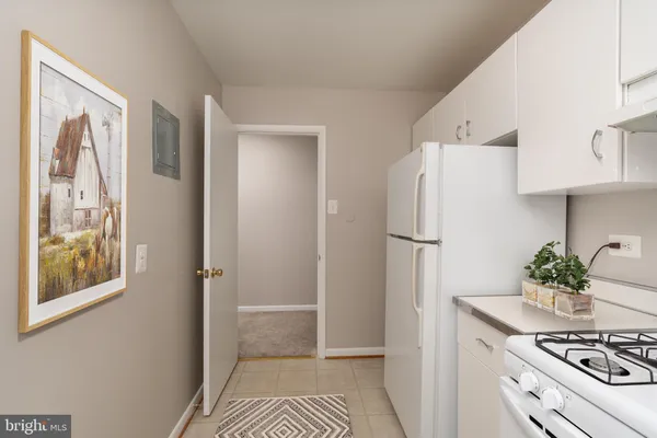 a white refrigerator freezer sitting inside of a kitchen