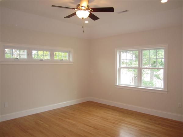 67 Hillcrest Road Waltham, MA 02451 - Photo 12 of 18 an empty room with wooden floor fan and windows