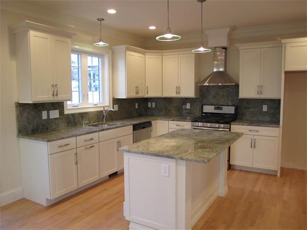 67 Hillcrest Road Waltham, MA 02451 - Photo 3 of 18 a kitchen with kitchen island granite countertop a sink a counter top space appliances and cabinets